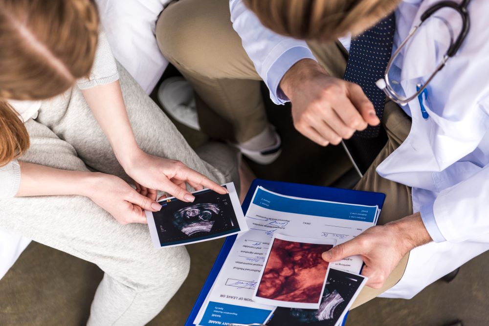 doctor and woman looking at ultrasound scans