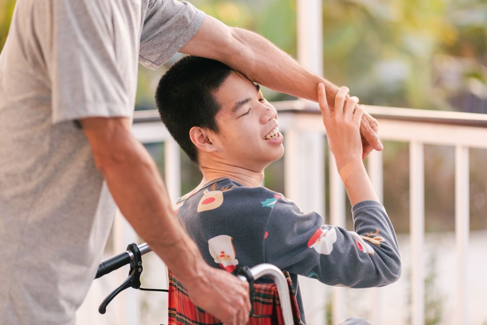 Teenager boy on wheelchair in the outdoor activity
