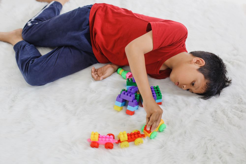 boy with Mixed Cerebral Palsy playing alone at home