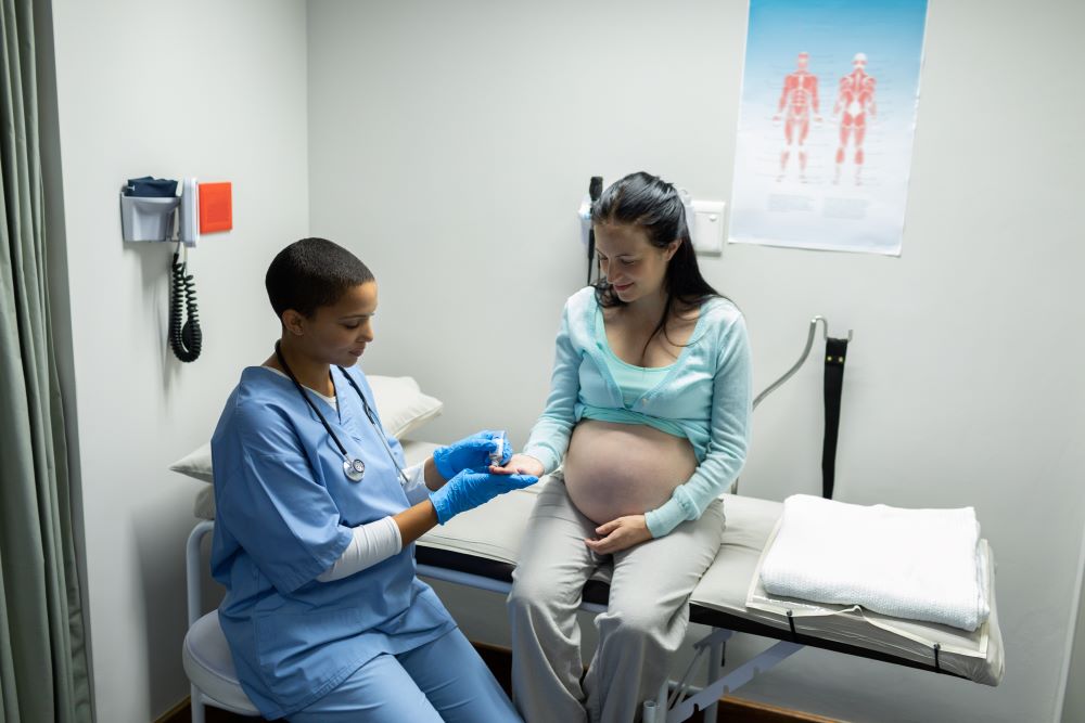 doctor taking blood test of a pregnant woman